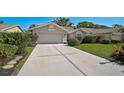 Inviting one-story home features a well-manicured lawn and lush landscaping, enhancing curb appeal at 6017 Marella Dr, Sarasota, FL 34243