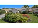 Beautiful home with a well-manicured lawn and vibrant flower beds adding pops of color at 6017 Marella Dr, Sarasota, FL 34243