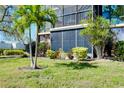 Building exterior showing lawn, garden, and screened in balcony at 612 Bird Bay S Dr # 116, Venice, FL 34285