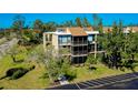 An aerial view of the condominium building exterior features balconies and parking at 612 Bird Bay S Dr # 116, Venice, FL 34285