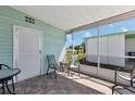 Screened-in lanai with neutral tile flooring and sliding window, offering a perfect spot for outdoor enjoyment at 633 Cervina S Dr, Venice, FL 34285