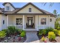 Charming home with a lovely front porch, manicured landscaping, and a welcoming walkway at 6540 The Masters Ave, Lakewood Ranch, FL 34202