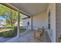 Inviting front porch with rocking chairs, offering a relaxing outdoor space at 6540 The Masters Ave, Lakewood Ranch, FL 34202