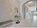 Elegant foyer featuring a glass table and modern mirror accents at 6620 35Th E Ct, Sarasota, FL 34243