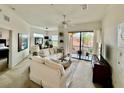 Bright living room featuring a neutral color palette, comfortable seating and a sliding glass door to the balcony at 8397 38Th Street E Cir # 306, Sarasota, FL 34243