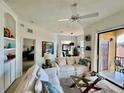 Inviting living room featuring comfortable seating, stylish decor, and access to a private balcony at 8397 38Th Street E Cir # 306, Sarasota, FL 34243