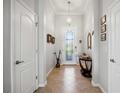 Welcoming entryway with tiled floor, decorative light fixture, and an elegant glass-paneled front door at 10008 Carnoustie Pl, Bradenton, FL 34211