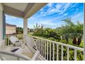 Inviting front porch seating area overlooking lush landscaping at 16966 Rosedown Gln, Parrish, FL 34219