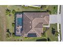 Aerial view of house showing pool, lanai, tile roof, landscaping, and driveway at 17045 Polo Trl, Bradenton, FL 34211
