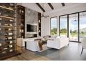 Bright living room with large windows, modern furnishings, and a sleek fireplace with marble accent wall at 2100 Mcclellan Pkwy, Sarasota, FL 34239
