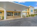 Condominium building entrance with covered area and signage, showcasing the building's facade at 2155 Wood St # A20, Sarasota, FL 34237