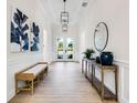 Bright foyer with wood flooring, pendant lighting, decor, and white walls creates an inviting entrance at 2246 Webber St, Sarasota, FL 34239