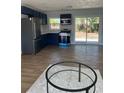 Bright, modern kitchen with stainless steel appliances and blue cabinets, flowing into the dining area at 2404 Lehigh Ave, Bradenton, FL 34207