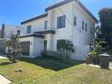 Stylish home featuring a modern design with a dark garage door, stone accents, and beautiful landscaping at 3204 W Grace St, Tampa, FL 33607