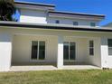 Covered patio with sliding glass doors, offering a seamless transition to outdoor living and backyard views at 3204 W Grace St, Tampa, FL 33607