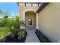 Inviting front entrance with an arched entryway and well-manicured landscaping for added curb appeal at 324 Casalino Dr, Nokomis, FL 34275