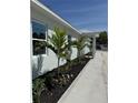 Close up of the home showcasing the landscaping and covered entryway at 3525 Mcintosh Rd, Sarasota, FL 34232