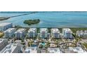 Exterior view of light blue condo building with white railings, and multiple parking spaces at 384 Aruba Cir # 103, Bradenton, FL 34209