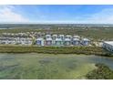 Aerial view of the condo complex surrounded by lush greenery and waterfront, showcasing the serene location at 384 Aruba Cir # 103, Bradenton, FL 34209