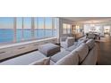 Beautiful living room with stylish decor, a cozy sofa, and large windows offering stunning water views at 400 Golden Gate Pt # 51 & 52, Sarasota, FL 34236