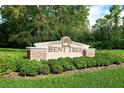 Entrance to Bent Tree, with manicured landscaping and lush greenery at 4320 Bent Tree Blvd, Sarasota, FL 34241