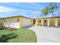 Inviting single-story home with a two-car garage and a well-maintained lawn at 4320 Bent Tree Blvd, Sarasota, FL 34241