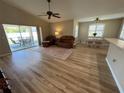 Living area with wood floors, sliding glass doors to lanai, and view of the dining area at 4636 72Nd E Ct, Bradenton, FL 34203