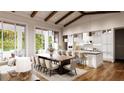 A view of the kitchen featuring hardwood floors, stone countertops, stainless appliances, and a large breakfast bar at 4644 Higel Ave, Sarasota, FL 34242