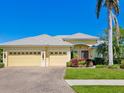 Charming single-story home with a three-car garage, beautiful landscaping and well-manicured lawn at 5087 Timber Chase Way, Sarasota, FL 34238