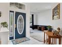 Elegant foyer with decorative front door, neutral walls, and view of a bedroom or living space at 5806 43Rd E Ct, Bradenton, FL 34203