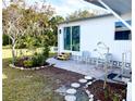 Backyard offers a brick-paver patio, lush garden, and tranquil outdoor seating area at 617 Cervina S Dr, Venice, FL 34285