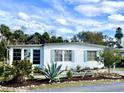 Inviting home with well-manicured landscaping, vibrant greenery, and a serene neighborhood setting at 617 Cervina S Dr, Venice, FL 34285