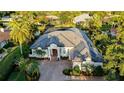 Aerial view of a luxury estate featuring lush landscaping, private pool, and gorgeous waterfront views at 7340 Barclay Ct, University Park, FL 34201