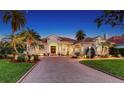 Beautiful home featuring a brick driveway, well-manicured landscaping, and an attached two-car garage at 7340 Barclay Ct, University Park, FL 34201