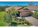Charming single-Gathering home with terra cotta roof, two-car garage, and lush landscaping at 8168 36Th E St, Sarasota, FL 34243