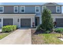 Well-maintained townhome with gray roof, light gray siding, and a neatly landscaped front yard at 8521 Canyon Creek Trl, Parrish, FL 34219