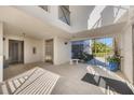 Bright and spacious lobby with tiled floors, an elevator, seating, and access to outdoor areas at 9203 Griggs Rd # A302, Englewood, FL 34224