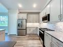 Well-lit kitchen features modern stainless-steel appliances, sleek countertops and ample cabinet space at 10006 Degas Ter, Bradenton, FL 34212