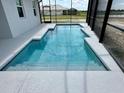 A private pool with seamless entry and bright tile, within a screened enclosure at 10006 Degas Ter, Bradenton, FL 34212