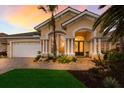 Close up of the front of the home showing the architectural detail, driveway and landscaping at 1009 3Rd E St, Palmetto, FL 34221