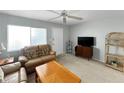 Comfortable living room featuring a ceiling fan, television, and ample seating at 11251 80Th Ave # 305, Seminole, FL 33772