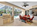 Covered outdoor dining area with a grill and view of the pool at 11835 Hollyhock Dr, Lakewood Ranch, FL 34202