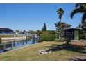 Waterfront backyard with a dock, shed, fire pit and lush landscaping, perfect for relaxation at 125 Palmetto Ne Cir, Port Charlotte, FL 33952