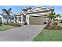Stunning single-Gathering home featuring a manicured lawn, paver driveway, and convenient two-car garage at 17907 Palmiste Dr, Bradenton, FL 34202