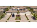 Aerial view of attached villa showing brick driveway and well maintained landscaping at 18113 Gawthrop Dr # 103, Bradenton, FL 34211