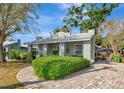 Home exterior boasting well-kept hedges and a circular brick driveway, enhancing curb appeal at 2021 Central Ave, Sarasota, FL 34234