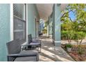 Comfortable outdoor seating on the porch, offering a relaxing space with shade and neighborhood views at 2021 Central Ave, Sarasota, FL 34234
