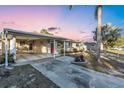 Inviting single-story home with covered carport, attractive landscaping, and a bright red front door provides great curb appeal at 2207 Holyoke Ave, Bradenton, FL 34207
