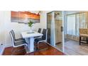 Modern dining area with seating for four and sliding glass doors to sun room at 2409 Gun Flint Trl, Palm Harbor, FL 34683