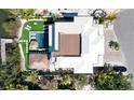 Aerial view of backyard featuring a pool, lush landscaping, a thatch cabana, and a private boat dock at 244 Willow Ave, Anna Maria, FL 34216